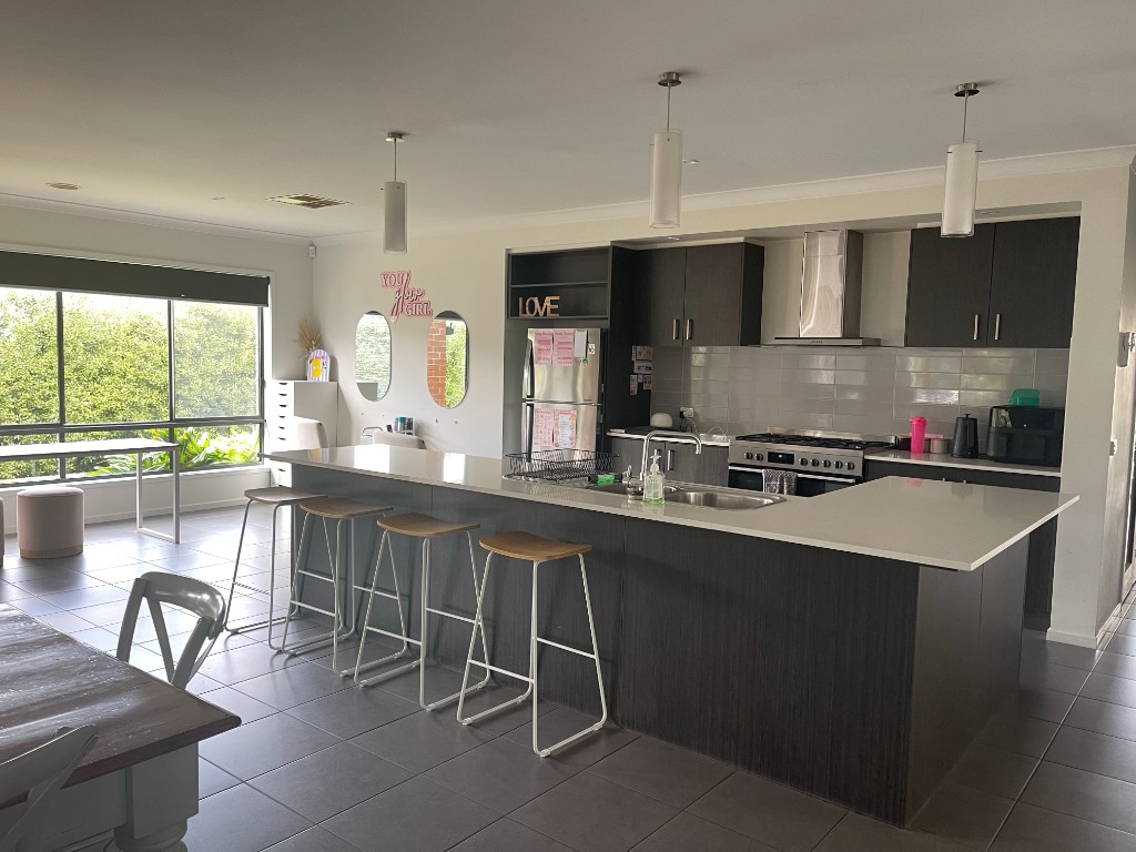 Open-plan kitchen and living area with island and natural light